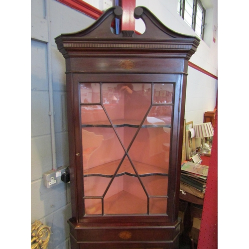 1083 - An Edwardian inlaid mahogany astragal glazed two door corner cabinet with key, the swan neck pedimen... 