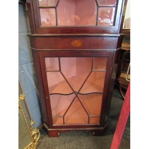 1083 - An Edwardian inlaid mahogany astragal glazed two door corner cabinet with key, the swan neck pedimen... 