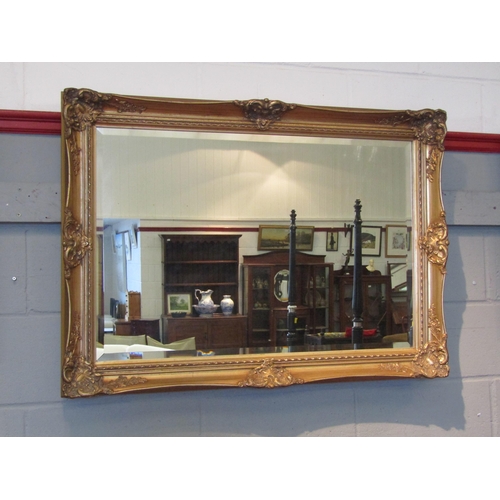 1085 - A modern classical style gilt metal wall mirror with pierced scrolled detail, urn top, 122cm x 72cm