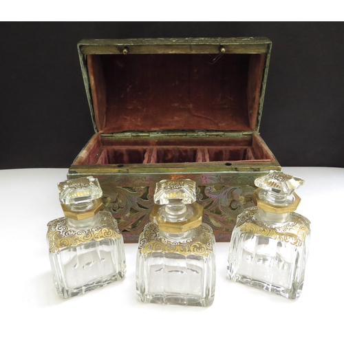 6336 - A domed shaped pierced brass velvet lined perfume casket containing three fitted cut glass perfume b... 