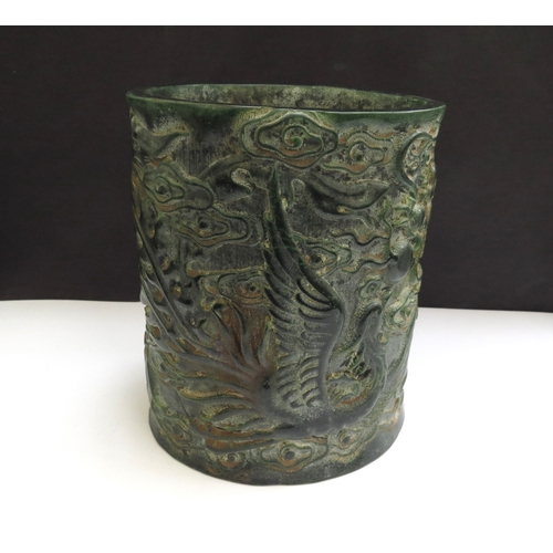 6339 - A Chinese jade brush pot decorated with a Ho-Ho bird and mythical dragon, impressed seal mark to bas... 