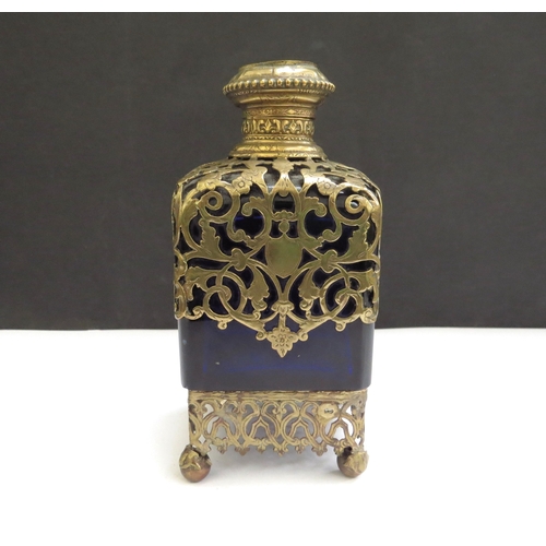 6340 - A Victorian Bristol Blue glass perfume bottle with ormolu overlay, lift up top with inlaid image and... 