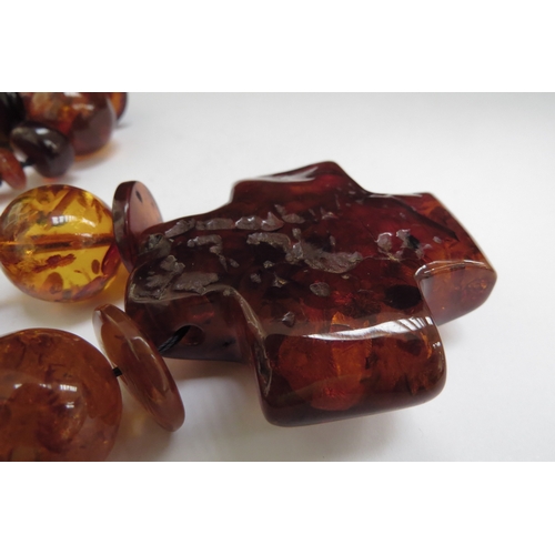 6487 - A large bead amber necklace with a large pendant,110cm long, 138g  (R)  £140