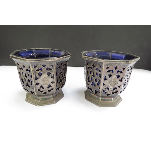 6500 - A pair of Victorian Henry Wilkinson & Co silver pierced condiment pots of octagonal form with blue g... 