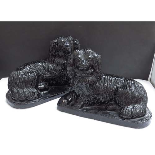 6192 - A pair of pottery 19th Chinese recumbant dogs, 15cm tall