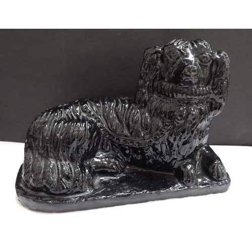 6192 - A pair of pottery 19th Chinese recumbant dogs, 15cm tall