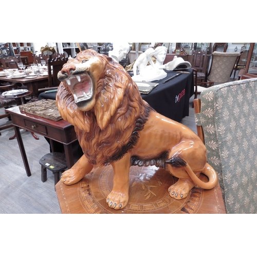 6136 - A Favaro Cecchello, Italy, figure of a lion roaring, 44cm tall, 57cm long