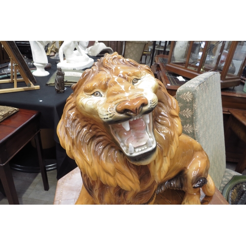 6136 - A Favaro Cecchello, Italy, figure of a lion roaring, 44cm tall, 57cm long