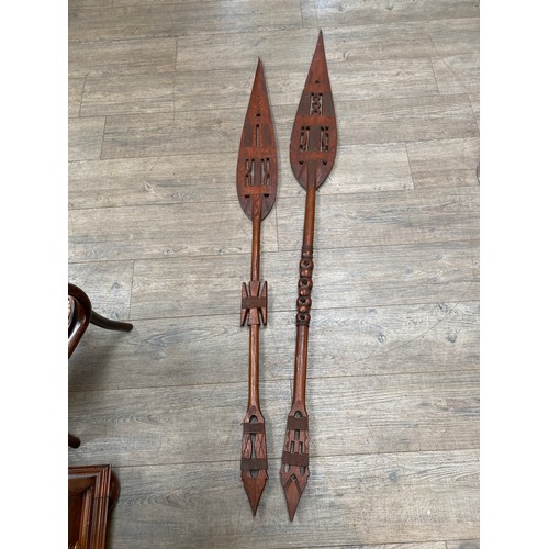 6106 - Two West African carved paddles, pierced geometric design, one a/f, 171cm & 154cm