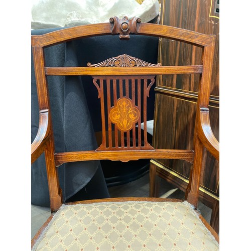 6117 - An Edwardian rosewood nursing chair, the pierced back support with central marquetry panel, on turne... 