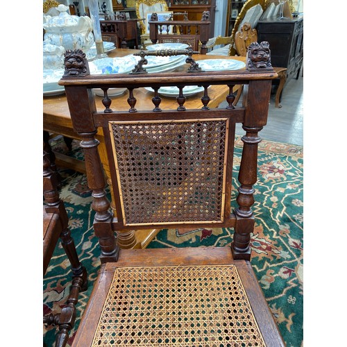 6170 - A set of six Victorian French oak Bergère dining chairs with decorative brass handles and carved lio... 