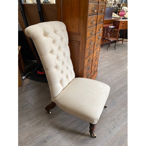 6104A - A Victorian button back nursing chair with oak legs to castors, 96cm tall x 50cm wide  (R)  £40