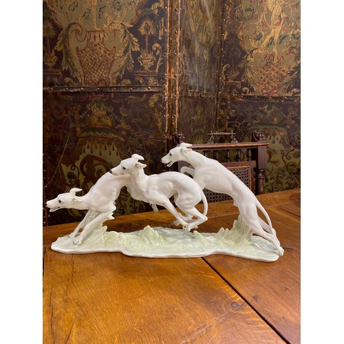 6253 - A figural group of greyhounds by Hutschenreuther, 23.5cm x 49cm long