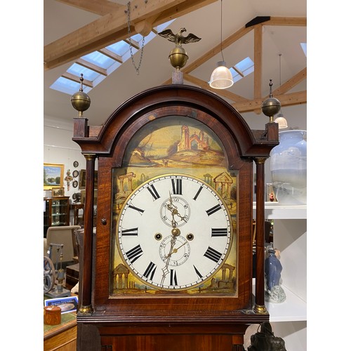 6255 - A Regency mahogany 8-day long case clock, with painted arch dial depicting ruins, Roman numeral dial... 