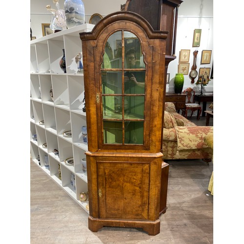 6288 - A walnut Queen Anne style corner cabinet, with arched top, glass panels revealing a painted shelved ... 