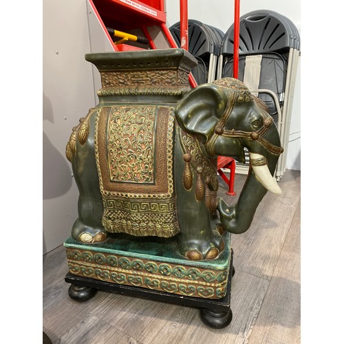 6311 - An elephant form jardiniere stand on wooden base with bun feet, 65.5cm x 55cm