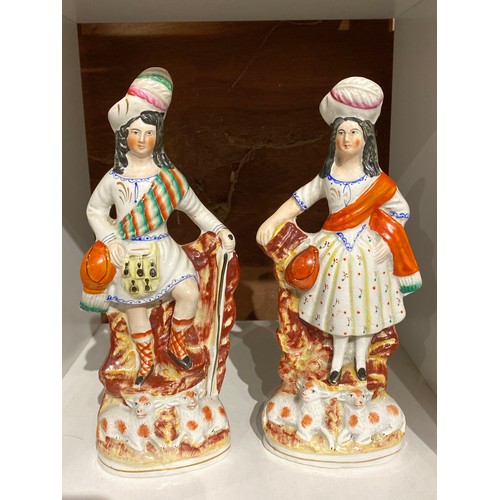 6313 - A pair of 19th century Staffordshire highland figures with lambs to base, 27cm & 26cm tall