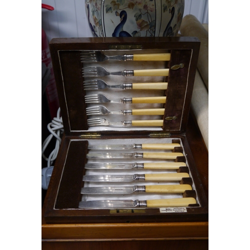 2495 - A box of cutlery and a candle stick     (R) £10