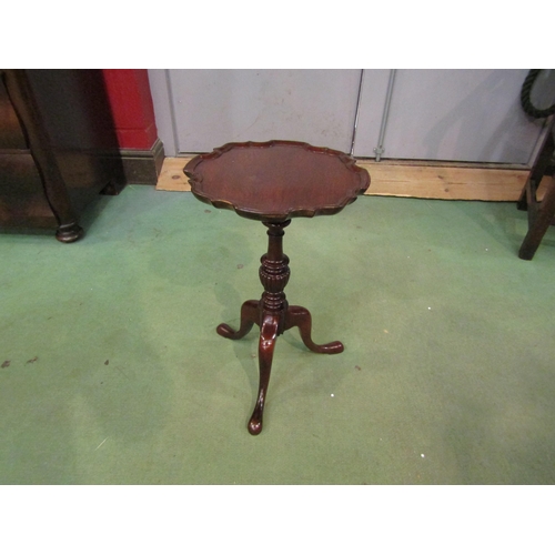 4011 - A George III style mahogany wine table the piecrust edge top over a turned and fluted column on a tr... 