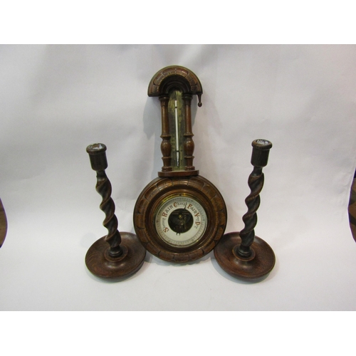 4035 - A wall barometer / thermometer (missing finial) together a pair of oak barley twist candlesticks (3)
