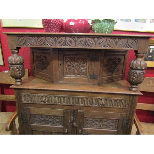 4050 - An Old Charm style oak court cupboard with carved detailing, single cupboard door top over single dr... 