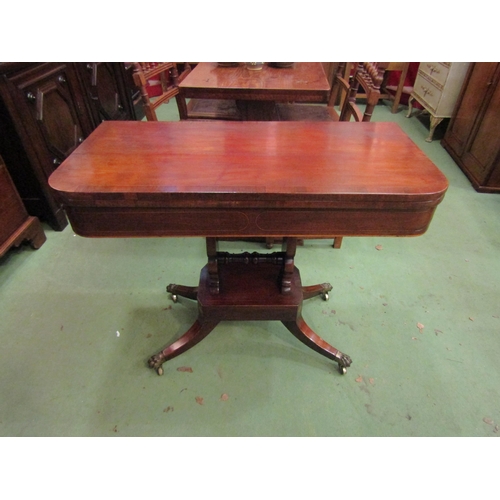 4077 - A Regency crossbanded flame mahogany D-shape fold-over top card table on a slab column and canted co... 