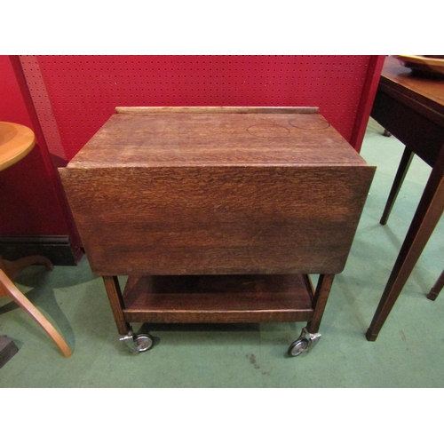 4087 - A circa 1950/60 Fyne Ladye of Banbury oak tea trolley with end drawer, the rising leaves over wheels... 