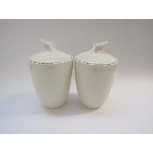 9061 - A pair of Belleek porcelain lidded canisters, c1980's mark, 23cm high