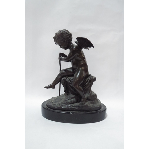 4003 - A bronze figure of a winged putti upon a perch holding a rod to slate base, 33cm tall, indistinctly ... 