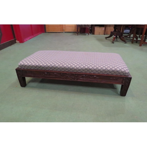 4022 - An Edwardian mahogany duet footstool the upholstered drop-in seat over a carved front with harebell ... 