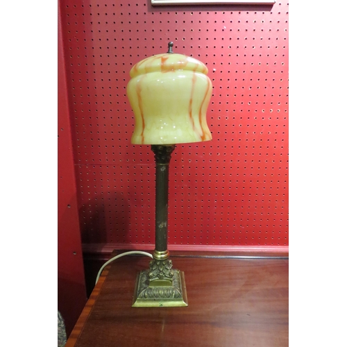 4029 - A Continental brass column table lamp with a yellow and amber mottle glass shade