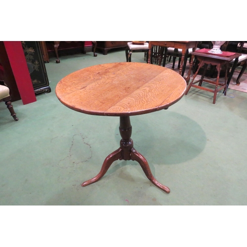 4105 - A George III country oak wine table, the circular top over a turned column to a tripod base, leg a/f... 