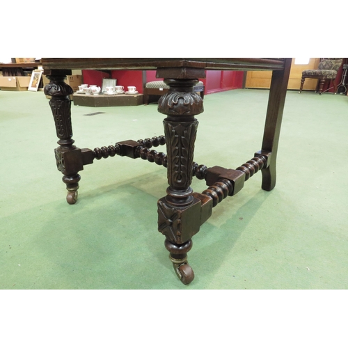 4106 - A Victorian carved walnut chair with carved fore legs on ceramic castors united by a bobbin turned 