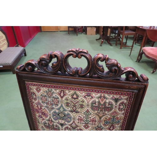 4106 - A Victorian carved walnut chair with carved fore legs on ceramic castors united by a bobbin turned 