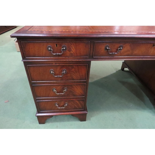 4107 - In the manner of Bevan & Funnell a George III style mahogany twin pedestal desk, the gilt tooled lea... 