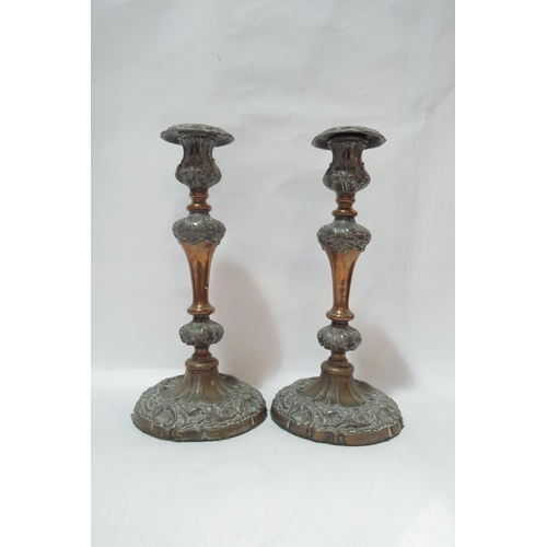 4111 - A pair of 19th Century Sheffield plate candlesticks, scrolled foliate relief, 31cm tall