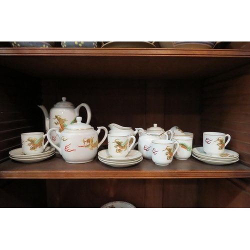 4136 - A quantity of 20th Century Japanese eggshell tea ware, dragon design enriched with gilt   (E) £15-25