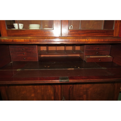 4138 - A Circa 1830 William IV flame mahogany country house bookcase on base, the two glazed doors with car... 