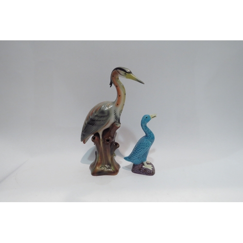 4439 - An Oriental blue porcelain cormorant 15cm tall, and a ceramic heron 26.5cm tall