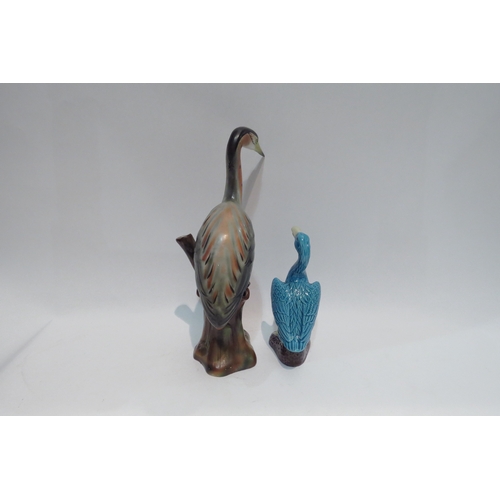 4439 - An Oriental blue porcelain cormorant 15cm tall, and a ceramic heron 26.5cm tall