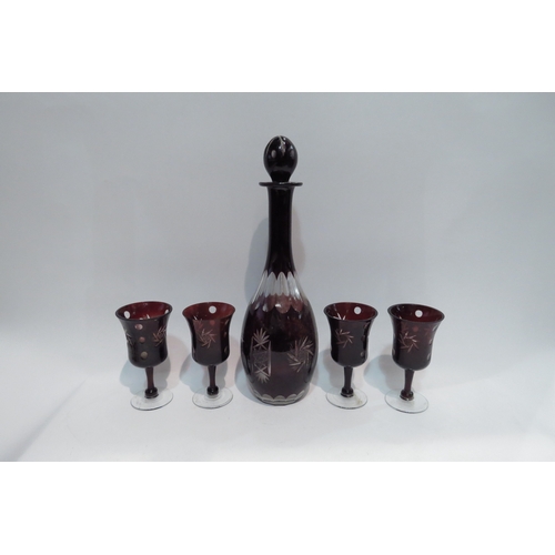 4440 - A Bohemian red glass decanter with four matching glasses