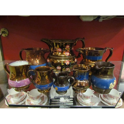 4005 - Eight lustre jugs of various sizes, tallest 17cm, smallest 6.5cm