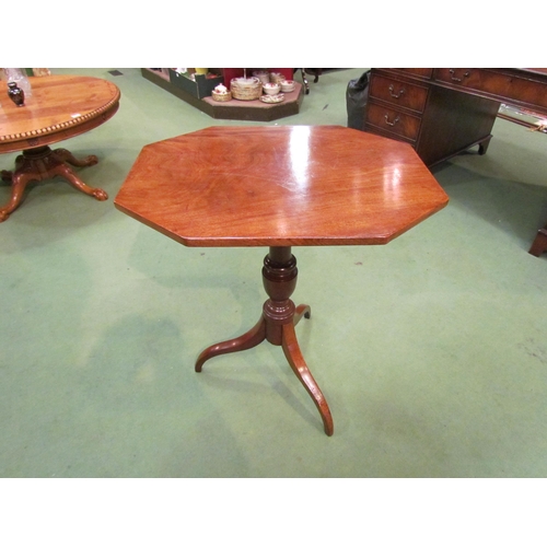 4075 - An early George III flame mahogany wine table, the canted corner tilt top over a vase shaped turned ... 