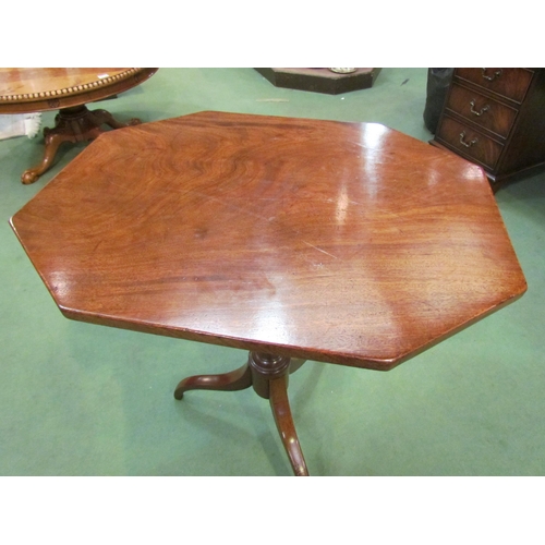 4075 - An early George III flame mahogany wine table, the canted corner tilt top over a vase shaped turned ... 