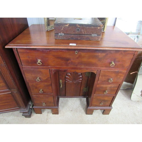 2124 - A mahogany knee hole desk, long drawer over six drawers, bracket feet