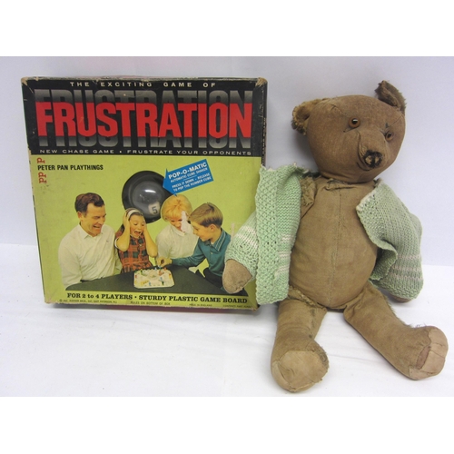 8312 - A careworn mid 20th Century straw filled teddy bear with glass eyes and a vintage Frustration board ... 