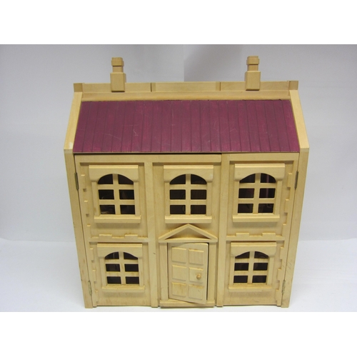 8265 - A two storey wooden dolls house with assorted wooden furniture       (E) £10-20