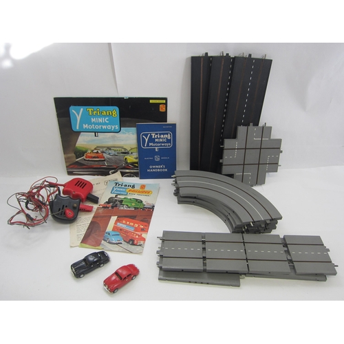 8387 - A collection of unboxed Triang Minic Motorways slot racing accessories including  two cars, two hand... 