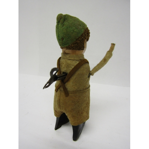 8236 - A Schuco clockwork tinplate figure of a Tyrolean boy in felt outfit, arms move when wound, 13cm tall