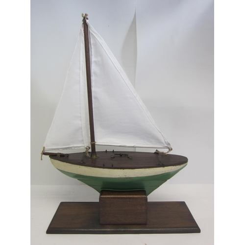 8434 - A scratch built wooden pond yacht with green and white painted hull and lead weighted keel, later wh... 